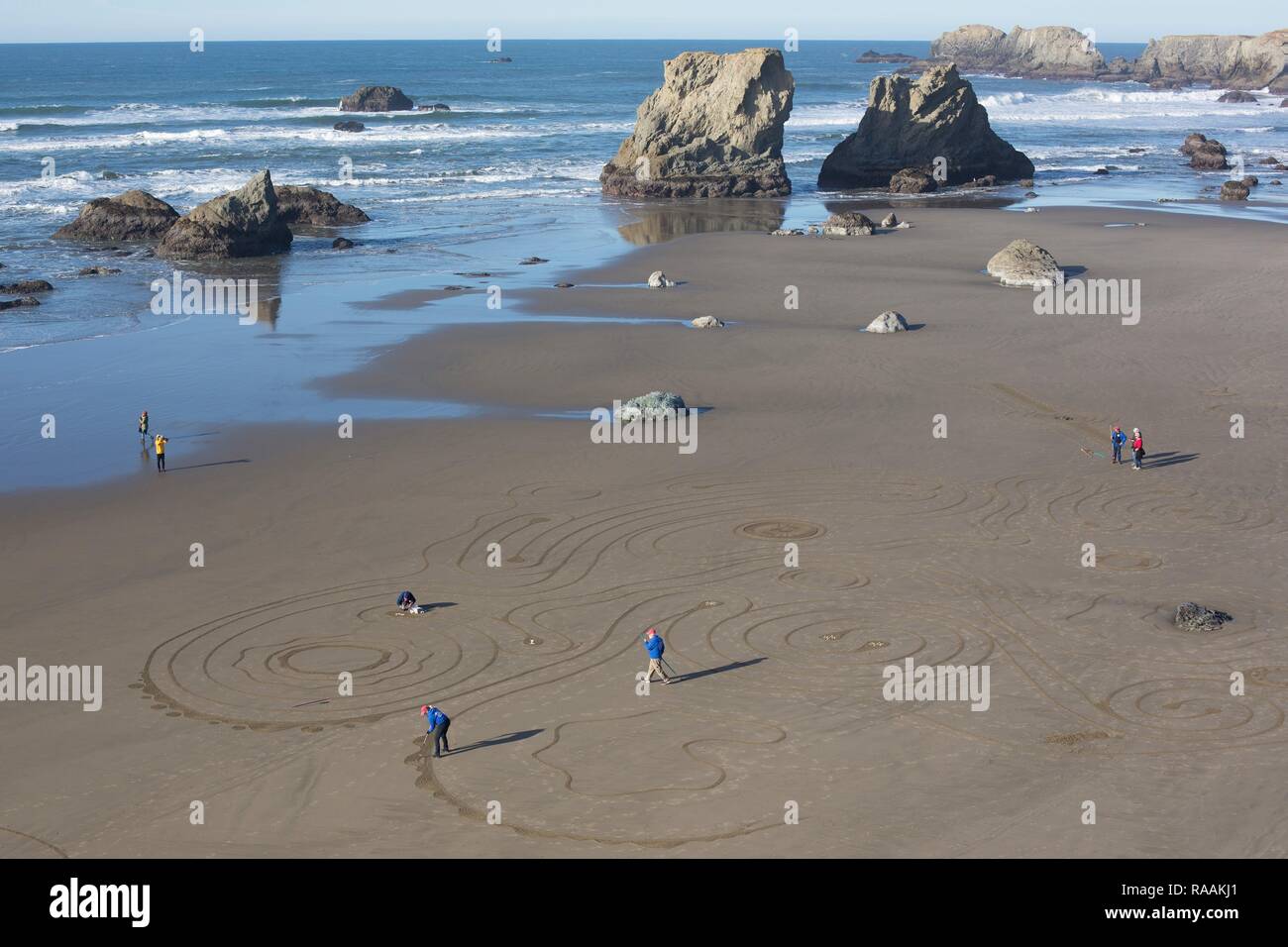 Volunteers working on a sand labyrinth created by the group 