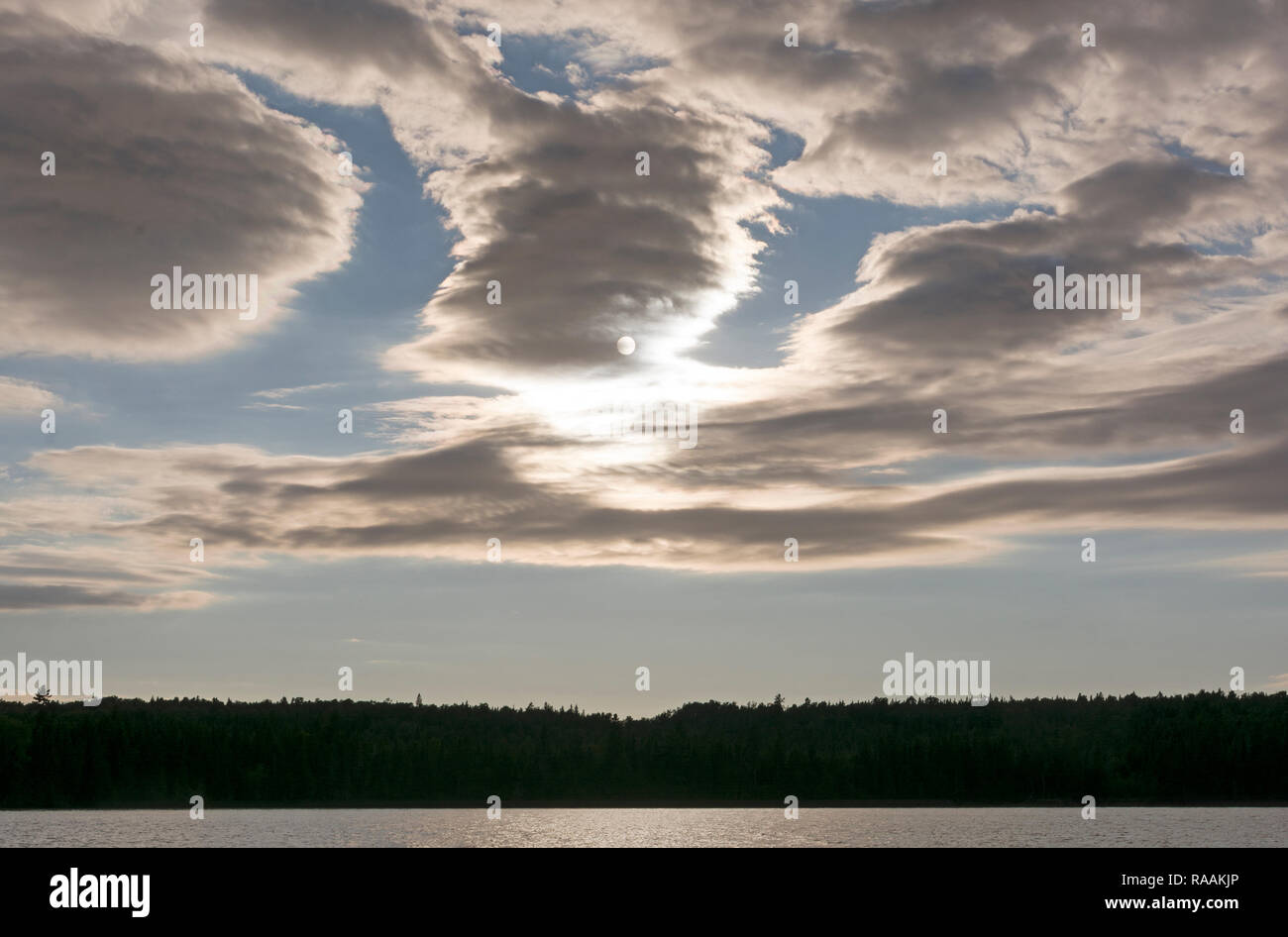 Dramatic Clouds and Sun over a Marie Louise Lake in Ontario Stock Photo