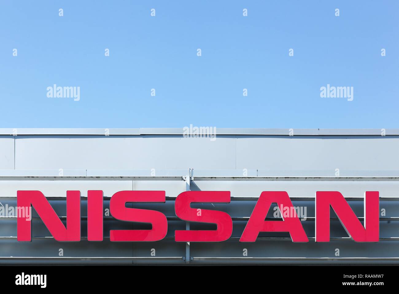 Aarhus, Denmark - August  12, 2015: Nissan logo on a facade. Nissan Motor Company Ltd, usually shortened to Nissan is a Japanese multinational Stock Photo