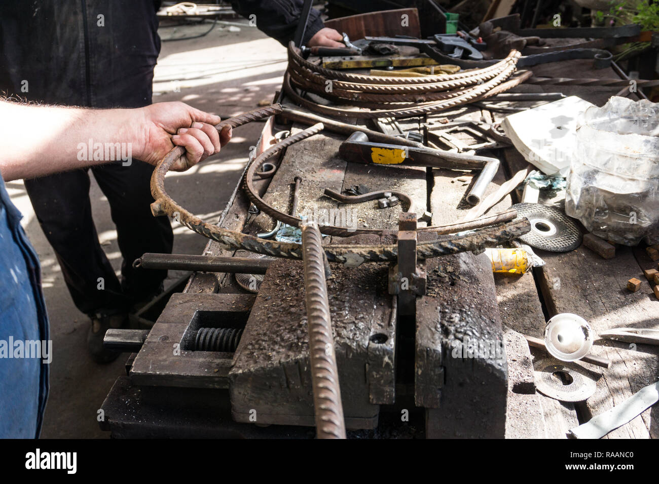 Blacksmith making wrought Iron with bender equipment machine for metal bending Stock Photo Alamy