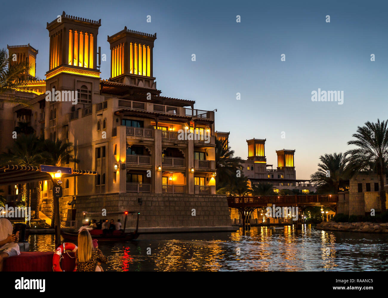 arabic architecture in Dubai souk madinat jumeirah at night with lights and reflections Stock Photo