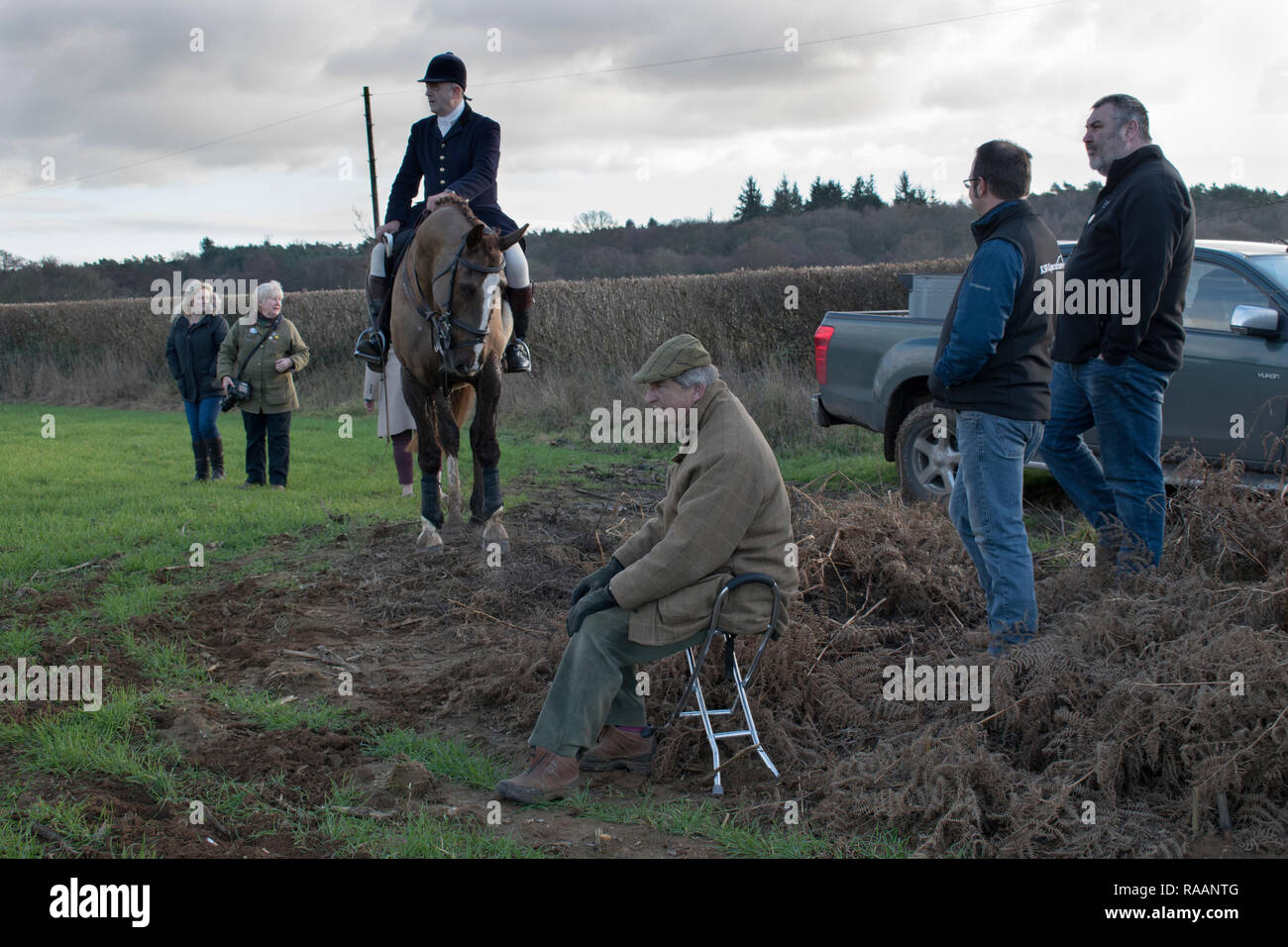 Fox hunting foot followers, older man sitting on a shooting stick. Chiddingfold Leconfield and Cowdray Hunt, New Years Day Midhurst West Sussex 2019. 2010s HOMER SYKES Stock Photo