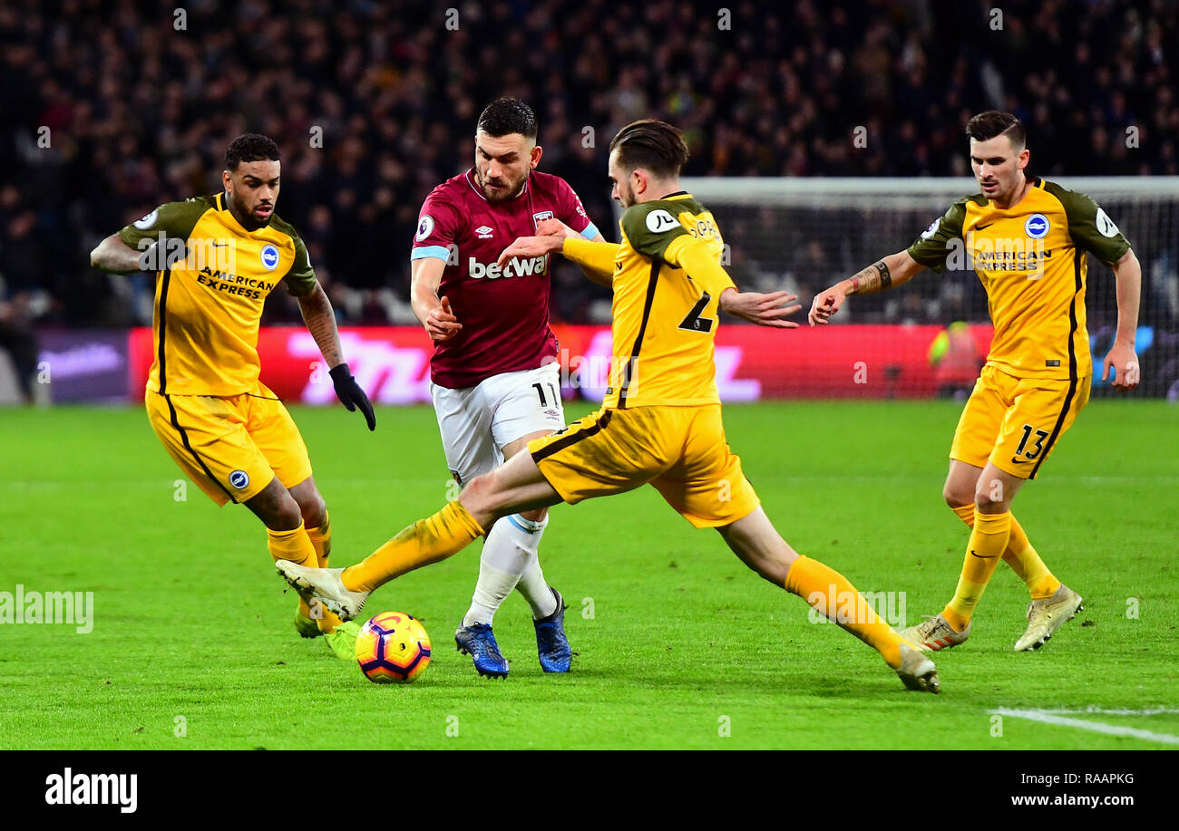 West Ham United's Robert Snodgrass (centre left) and Brighton & Hove Albion's Davy Propper battle for the ball during the Premier League match at the London Stadium. Stock Photo