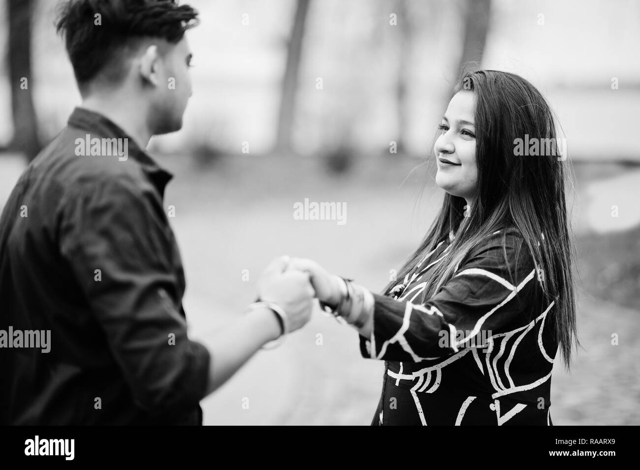Love story of indian couple posed outdoor, holding hands together. Stock Photo