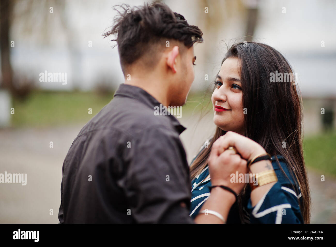 Love Story Of Indian Couple Posed Outdoor Holding Hands Together Stock