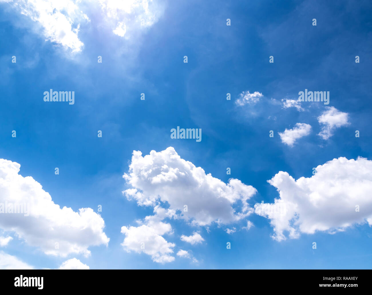 Fluffy clouds in the bright blue sky Stock Photo - Alamy