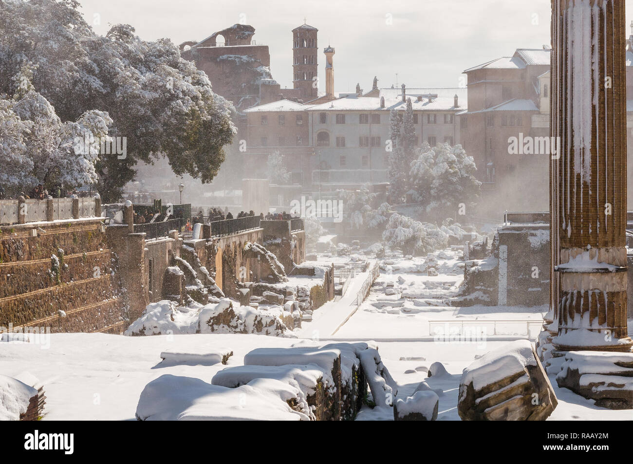 Snowing in Rome. Roman and Caesar Forum ancient ruins covered with snow Stock Photo