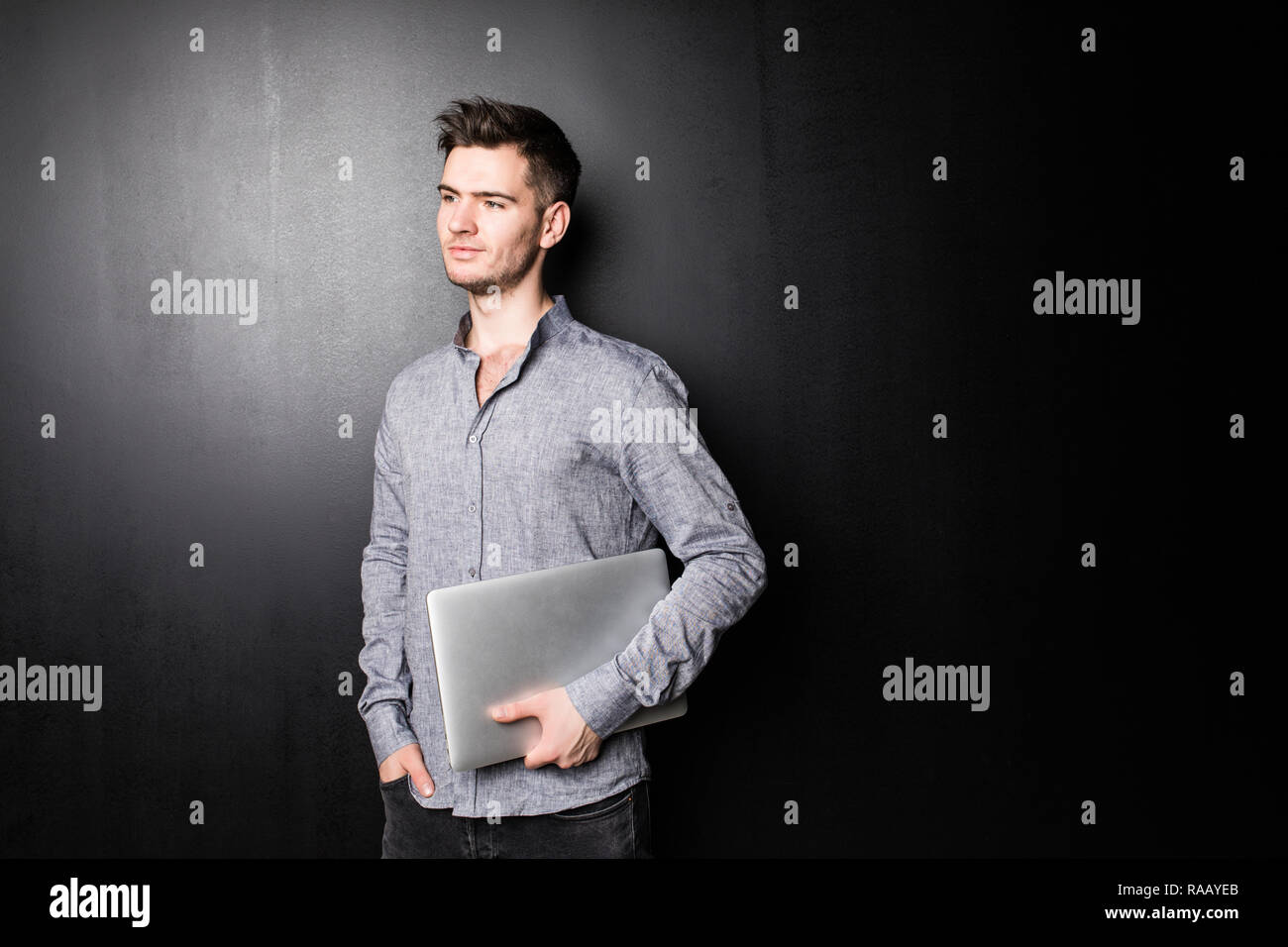 Smiling man using his laptop on white background Stock Photo