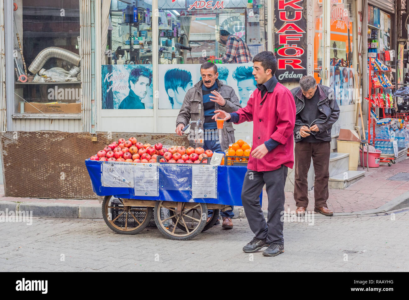 Istanbul, Turkey, January 21. 2015: Turkish man selling pomegranate and orange juices in the street in Aksaray. Stock Photo