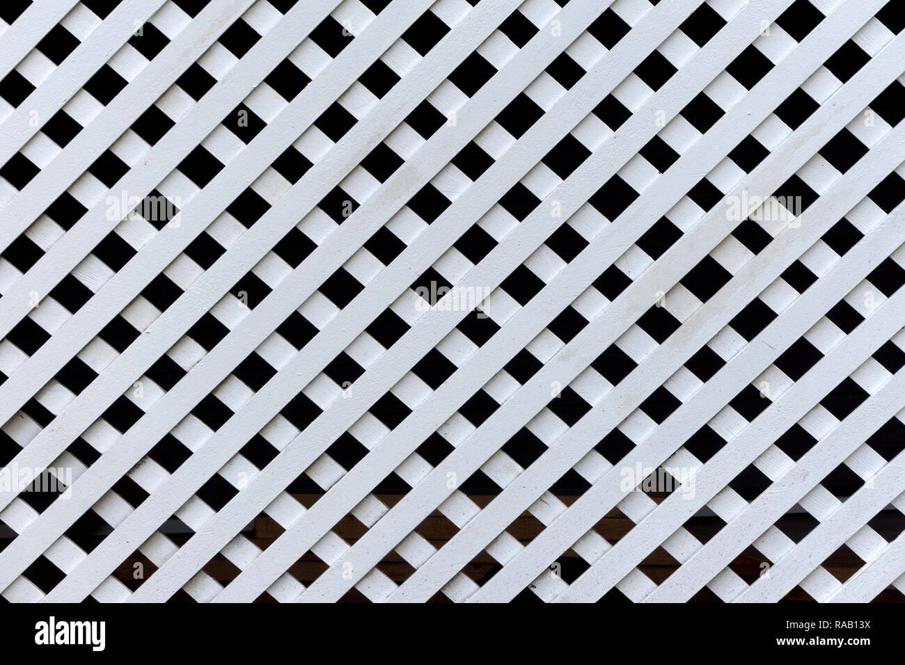 White wooden lattice backdrop with black background and repeating