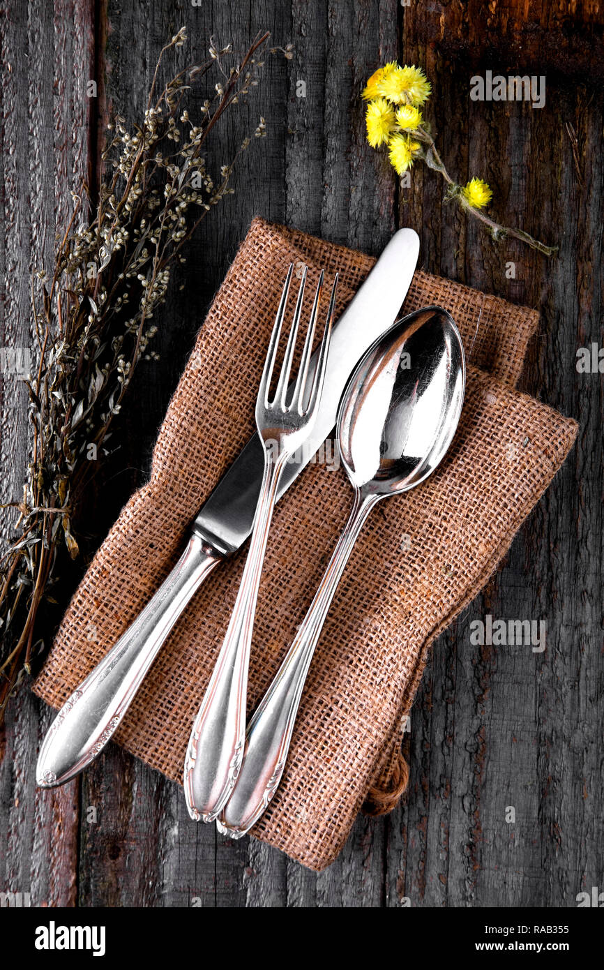 old silver cutlery on wooden background Stock Photo