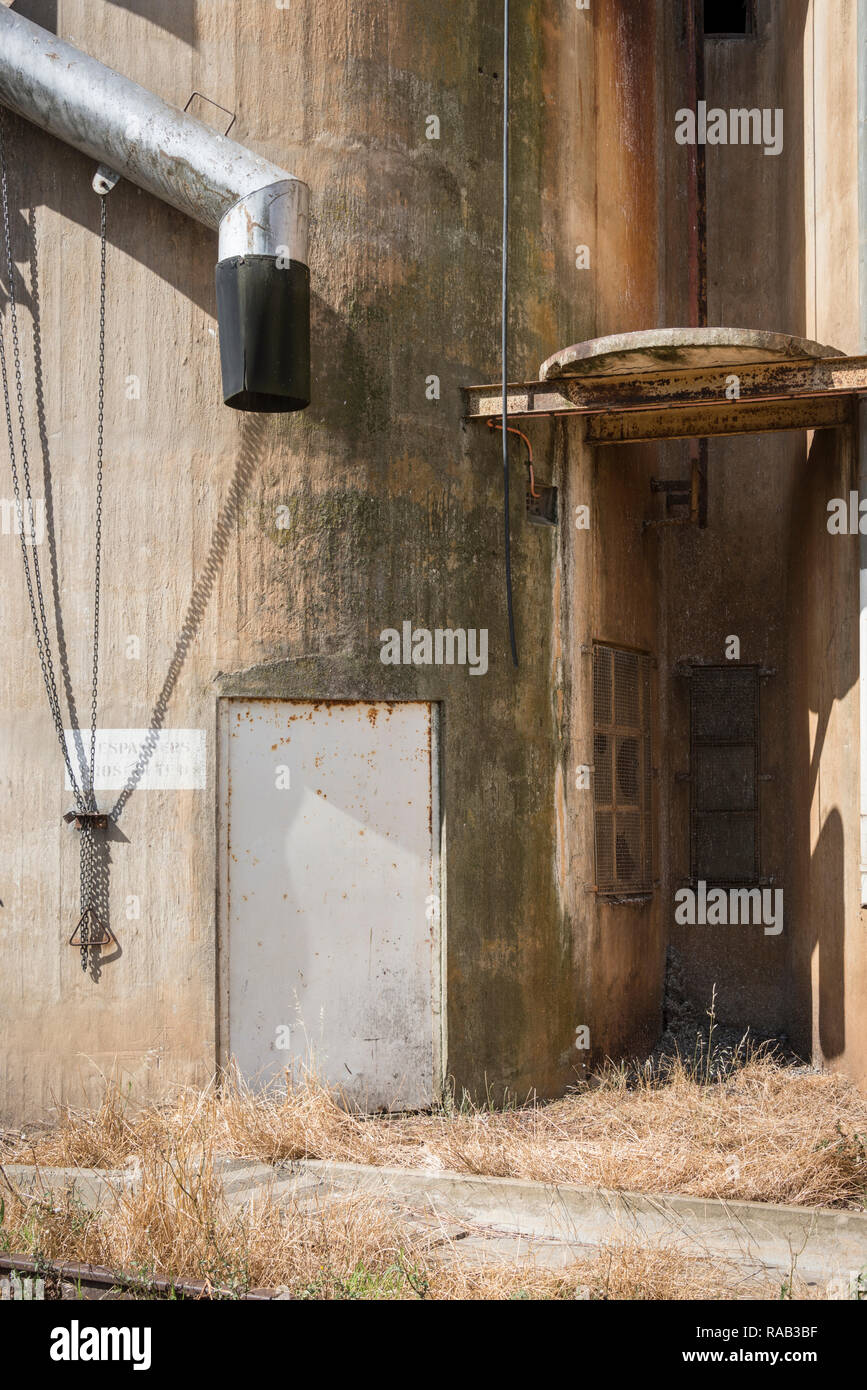 Door and loading shoot on the side of an old rail-side grain silo Stock Photo