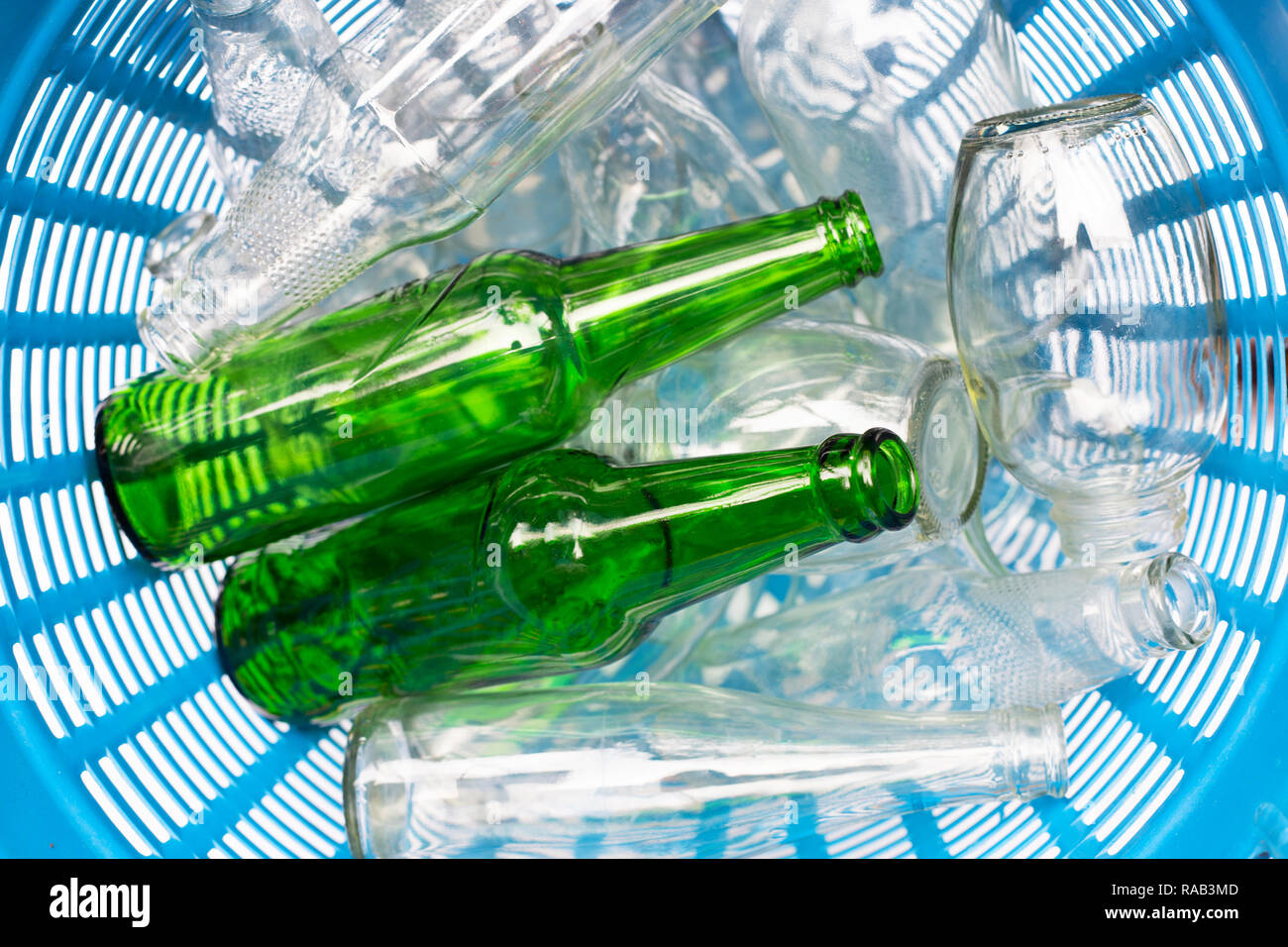Glass bottles in blue waste basket Stock Photo Alamy