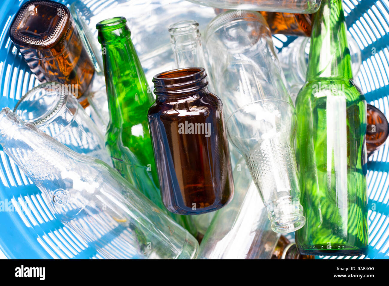 Glass bottles in blue waste basket Stock Photo Alamy