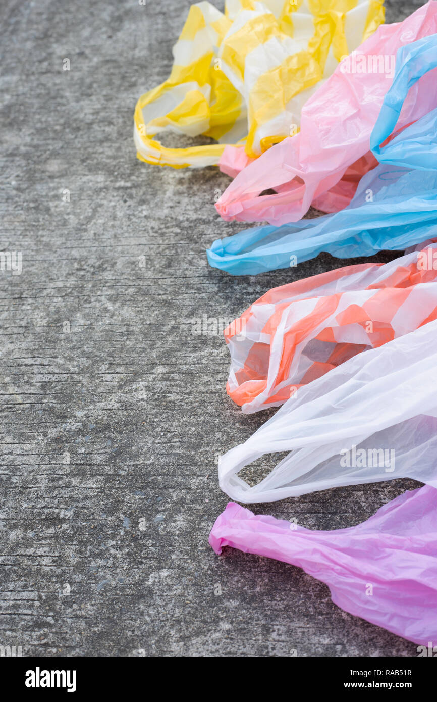 Plastic garbage bags on cement floor. Copy space Stock Photo
