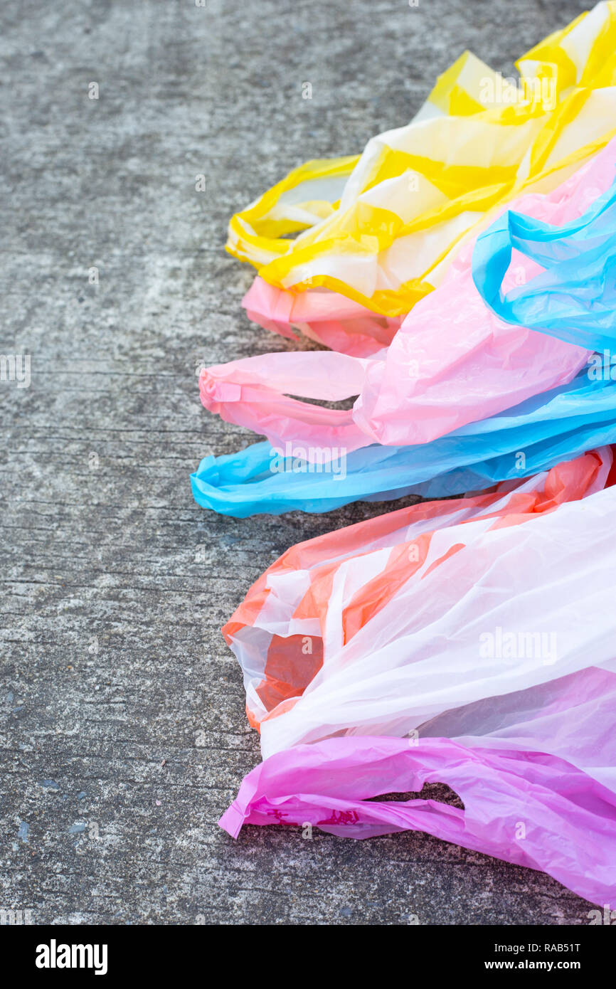 Plastic garbage bags on cement floor background. Stock Photo