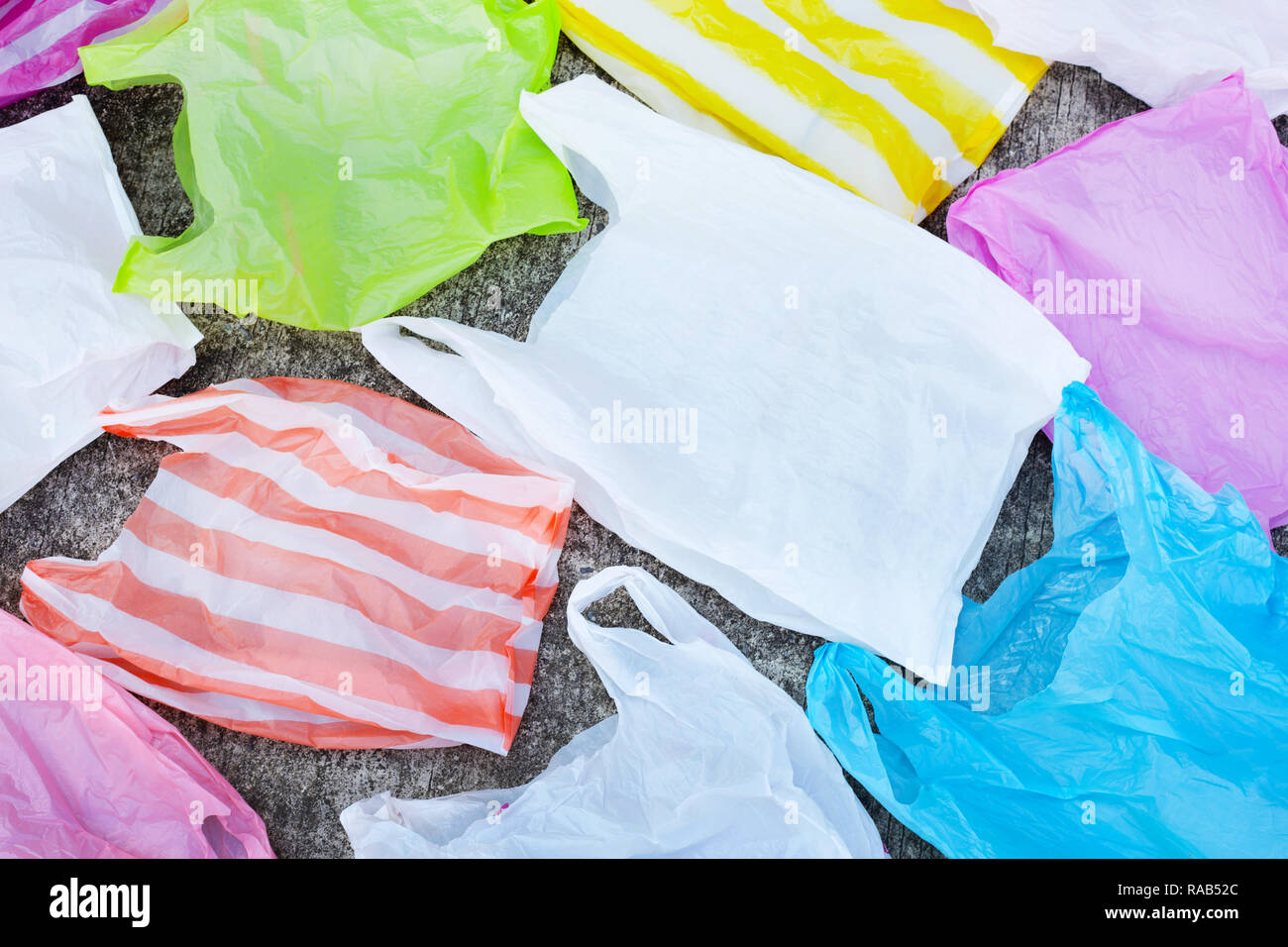 Plastic garbage bags on cement floor background. Stock Photo