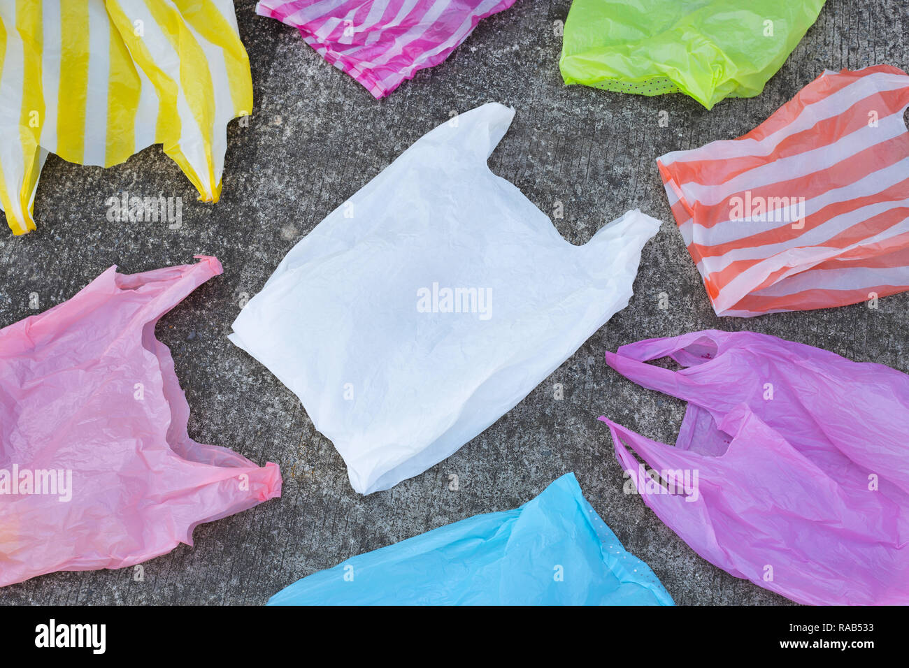 Plastic garbage bags on cement floor. Top view Stock Photo