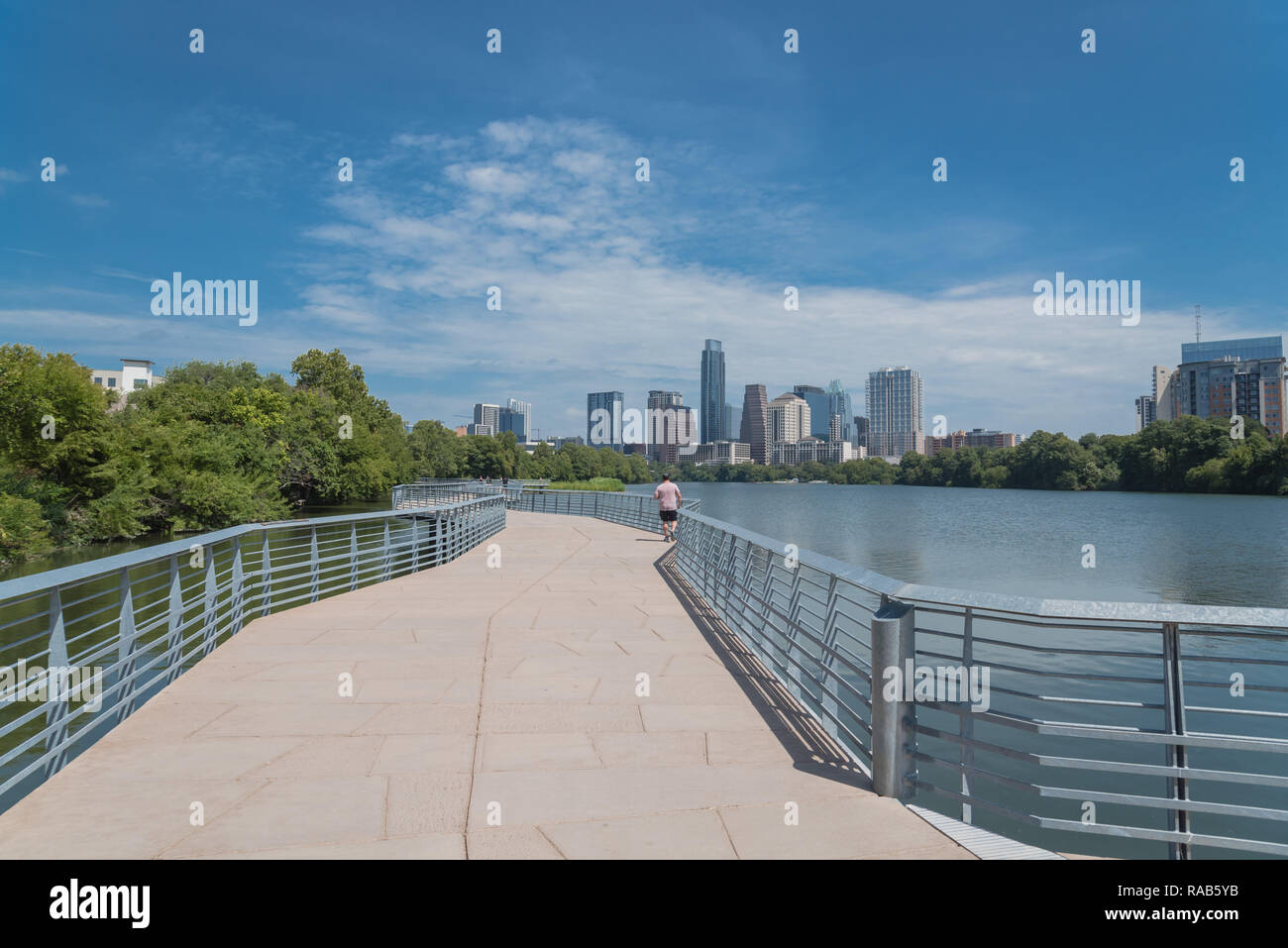 People enjoy outdoor activities on boardwalk in downtown Austin Stock