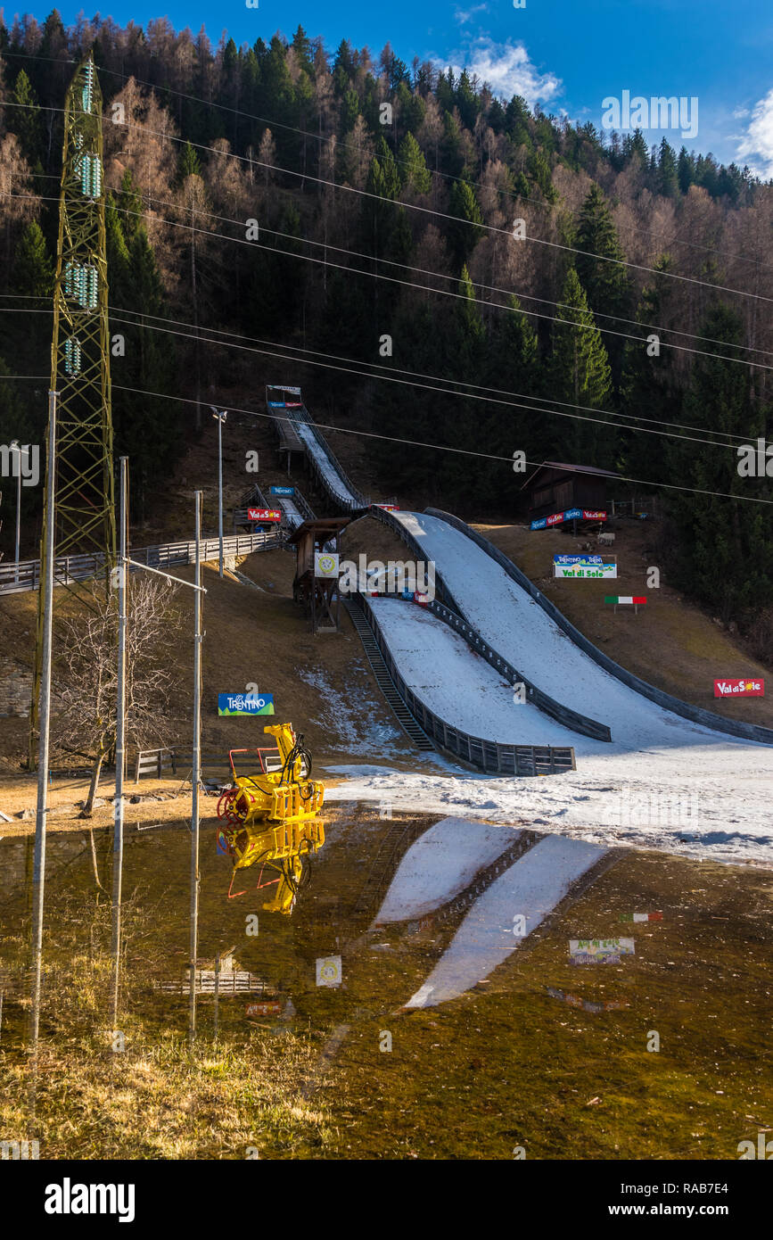 Ski jump ramp in spring. Water and snow. Pellizzano, small town in Ski region Val di Sole, Trento, Trentino, Italy Stock Photo