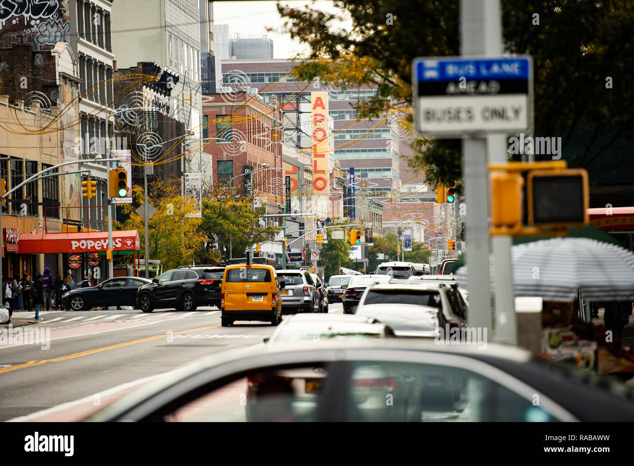 Daily life in Harlem with the famous Apollo theatre in the background. Stock Photo