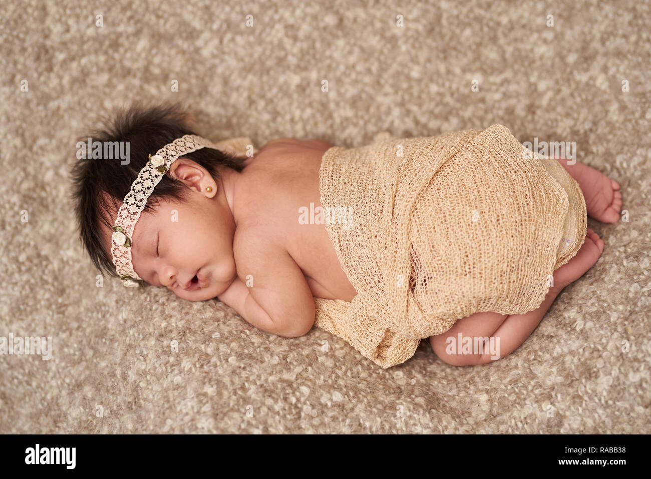 Above view of small sleeping newborn baby on brown soft blanket Stock Photo