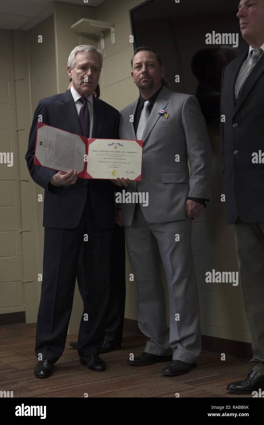 The Secretary of the Navy, Ray Mabus, presents the Silver Star to Master Sgt. Steven Davis (Ret) during an award ceremony at Marine Corps Air Station Cherry Point, N.C., Jan. 13, 2017. Davis received the Silver Star for conspicuous gallantry and intrepidity in action against the enemy while serving as a Section Leader with Weapons Company, 1st Battalion, 8th Marines, Regimental Combat Team 7, 1st Marine Division, in support of Operation Iraqi Freedom. Stock Photo