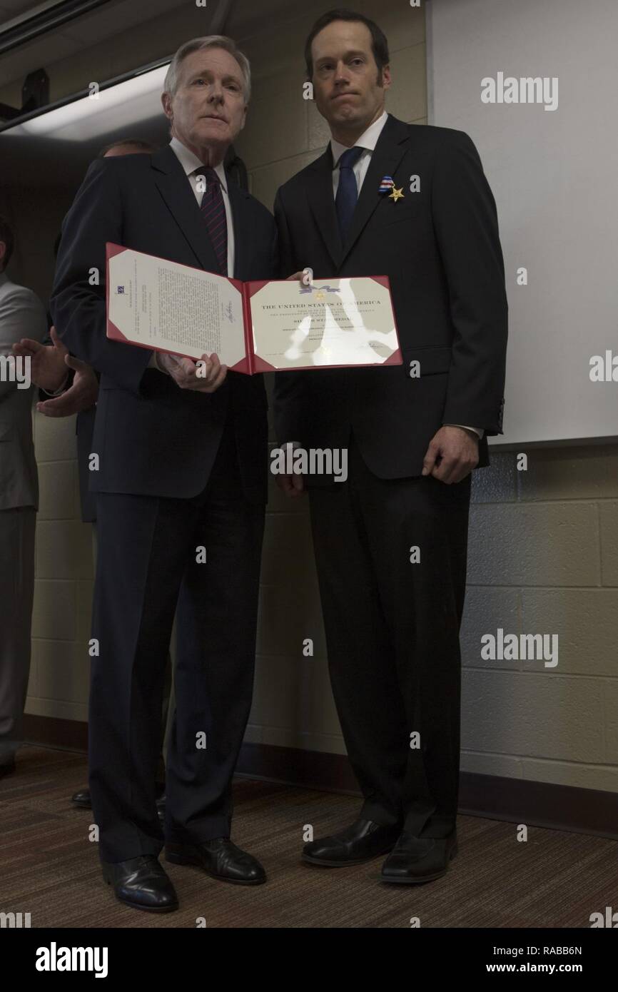 The Secretary of the Navy, Ray Mabus, presents the Silver Star to Sgt. Nicholas Brandau during an award ceremony at Marine Corps Air Station Cherry Point, N.C., Jan. 13, 2017. Brandau received the Silver Star for conspicuous gallantry and intrepidity in action against the enemy as Squad Leader, Company D, 1st Battalion, 7th Marines, Regimental Combat Team 6, 1st Marine Division, I Marine Expeditionary Force in support of Operation Enduring Freedom. Stock Photo