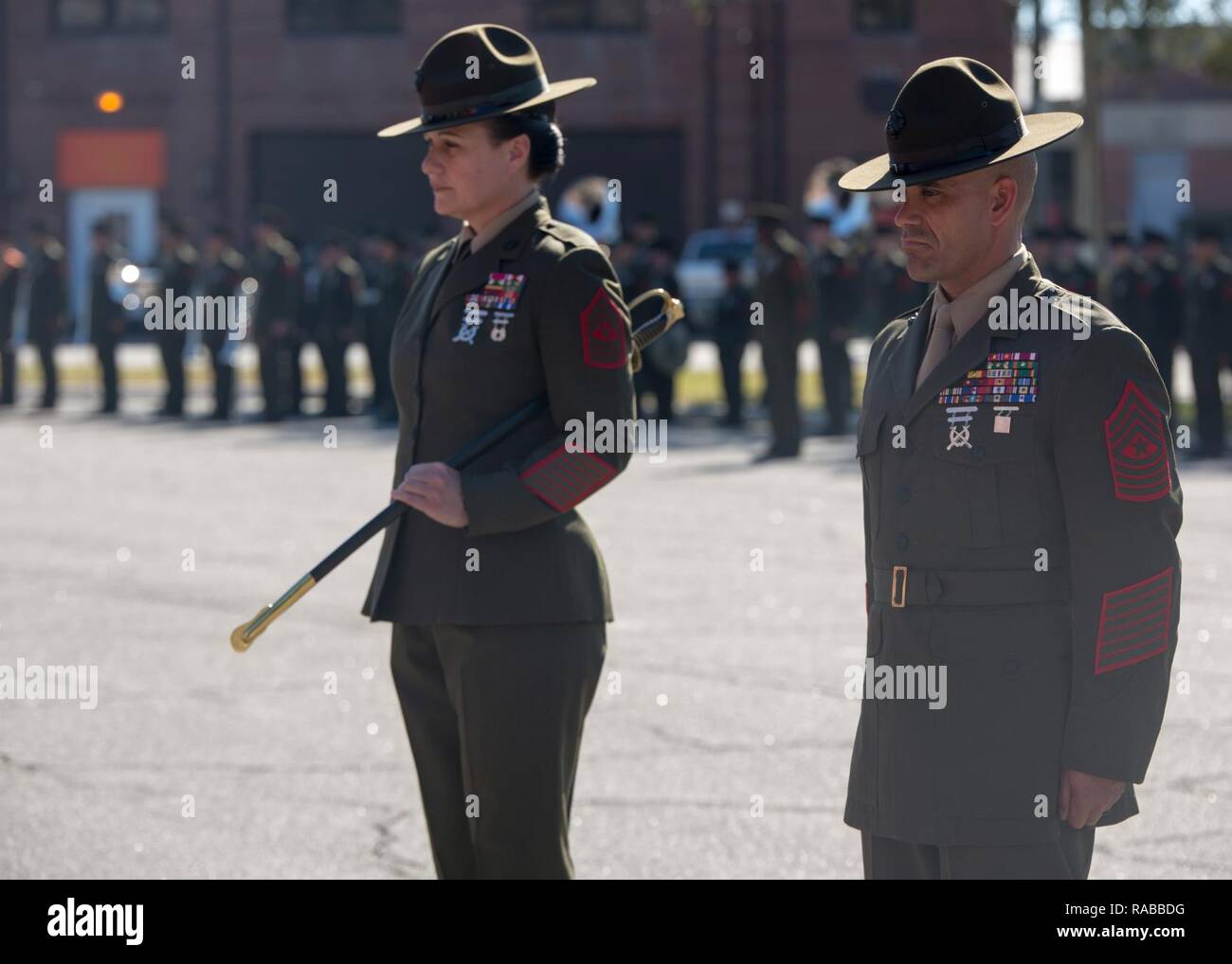 Sgt. Maj. Rafael Rodriguez stands at attention next to Sgt. Maj. Angela M. Maness during a relief and appointment ceremony Jan. 13, 2017, on Parris Island, S.C. Maness relinquished her post as the Marine Corps Recruit Depot Parris Island and Eastern Recruiting Region sergeant major to Rodriguez, who comes to the depot from Headquarters Regiment, 1st Marine Logistics Group. Stock Photo