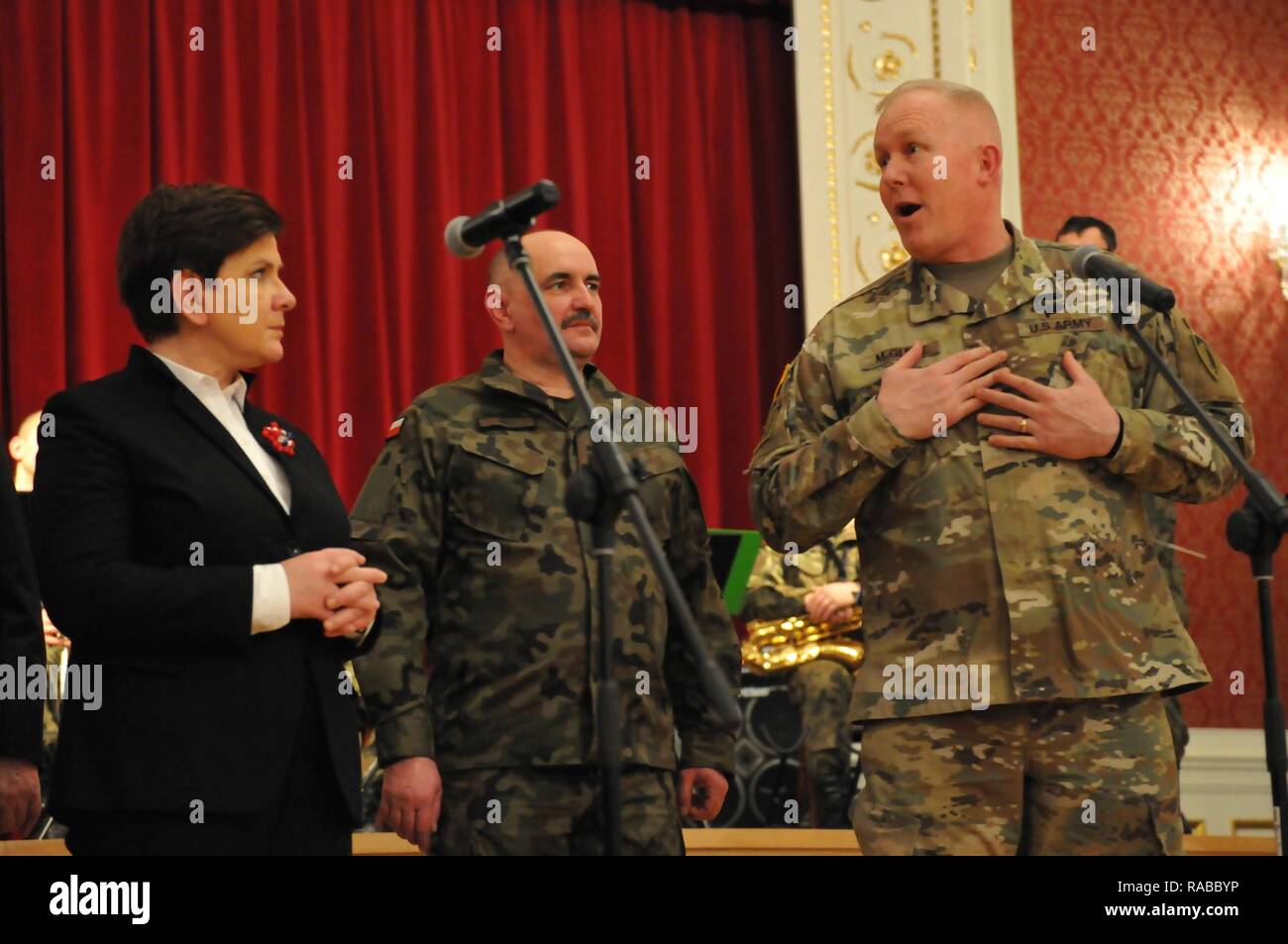 (right) U.S. Army Maj. Gen. Timothy McGuire, deputy commanding general, U.S. Army Europe, speaks (left) Polish Prime Minister Beata Szydlo, dignitaries, and U.S. and Polish Soldiers during an informal dinner on Safe Poland Day in the Crystal Palace in Zagan, Poland, January 14, 2017. U.S. Army Soldiers assigned to 3rd Armored Brigade Combat Team, 4th Infantry Division, recently arrived in Poland, marking the start of back-to-back rotations of armored brigades in Europe as part of Operation Atlantic Resolve. Vehicles and equipment, totaling more than 2,700 pieces, are being shipped to Poland fo Stock Photo