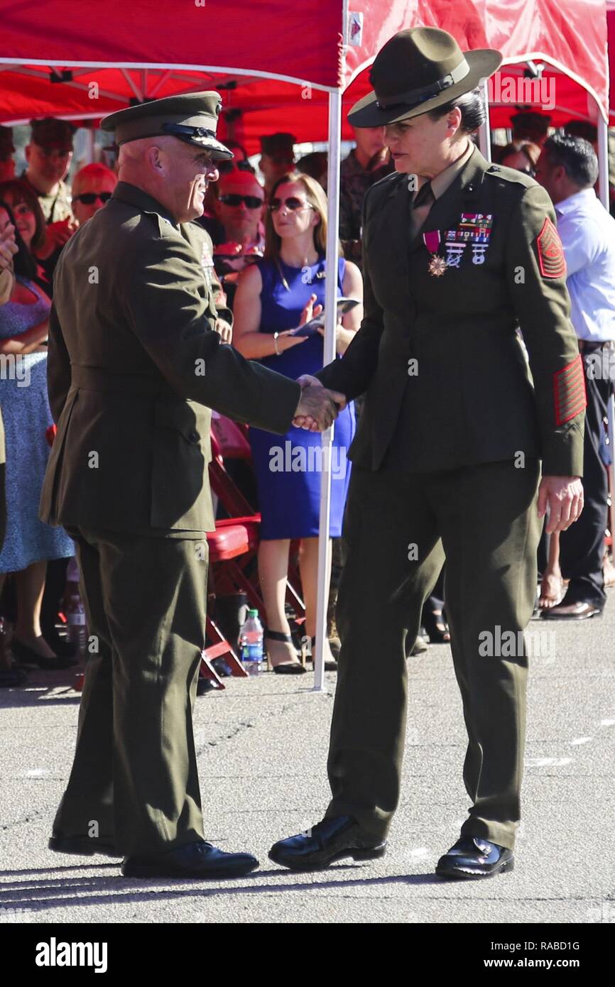 U.S. Marine Corps Brig. Gen. Austin E. Renforth, the Commanding General of Marine Corps Recruit Depot Parris Island (MCRD PI)/Eastern Recruiting Region (left), shakes hands with Sgt. Maj. Angela M. Maness, the former Sergeant Major of MCRD PI/Eastern Recruiting Region, during the relief and appointment ceremony for the MCRD PI/Eastern Recruiting Region Sergeant Major at the General’s Building on MCRD PI, S. C., Jan. 13, 2017. Maness retired after 30 faithful years of service and was relieved of her duty as MCRD PI/Eastern Recruiting Region Sergeant Major by Sgt. Maj. Rafael Rodriguez. Stock Photo