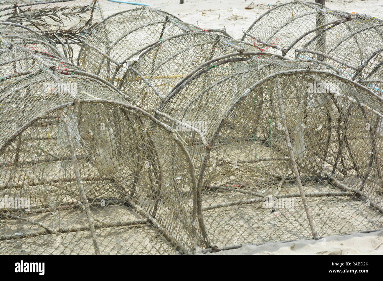 Crab traps stacked near bay in Thailand Stock Photo - Alamy