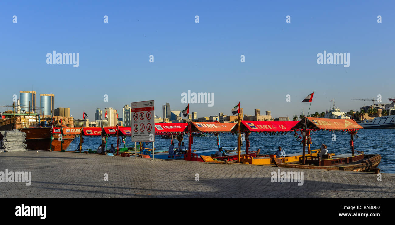 Dubai, UAE - Dec 9, 2018. Wooden boat (water bus) on Dubai Creek. The creek is a man-made waterway made for the convenience of trade ships. Stock Photo