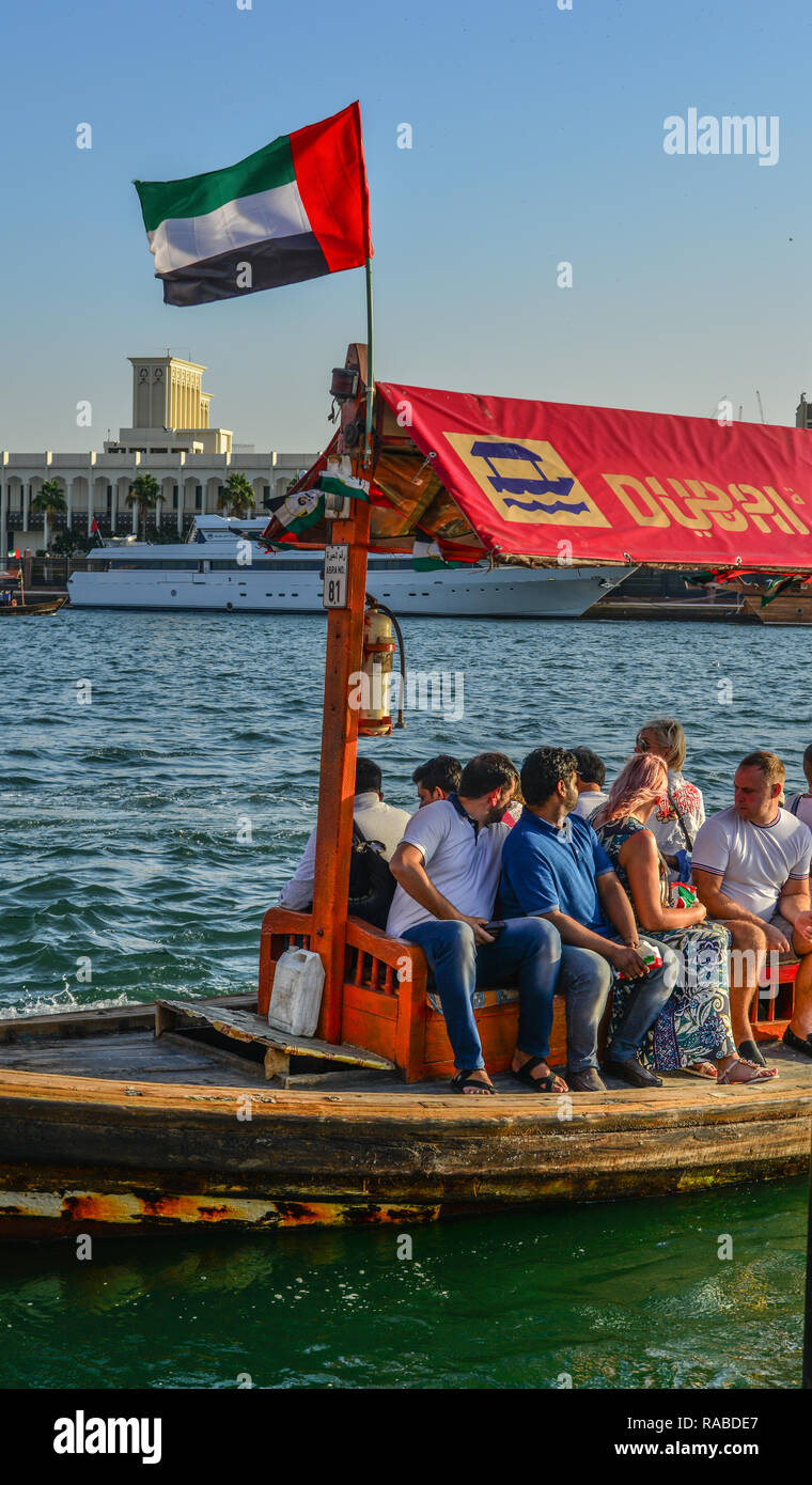 Dubai, UAE - Dec 9, 2018. Wooden boat (water bus) on Dubai Creek. The creek is a man-made waterway made for the convenience of trade ships. Stock Photo