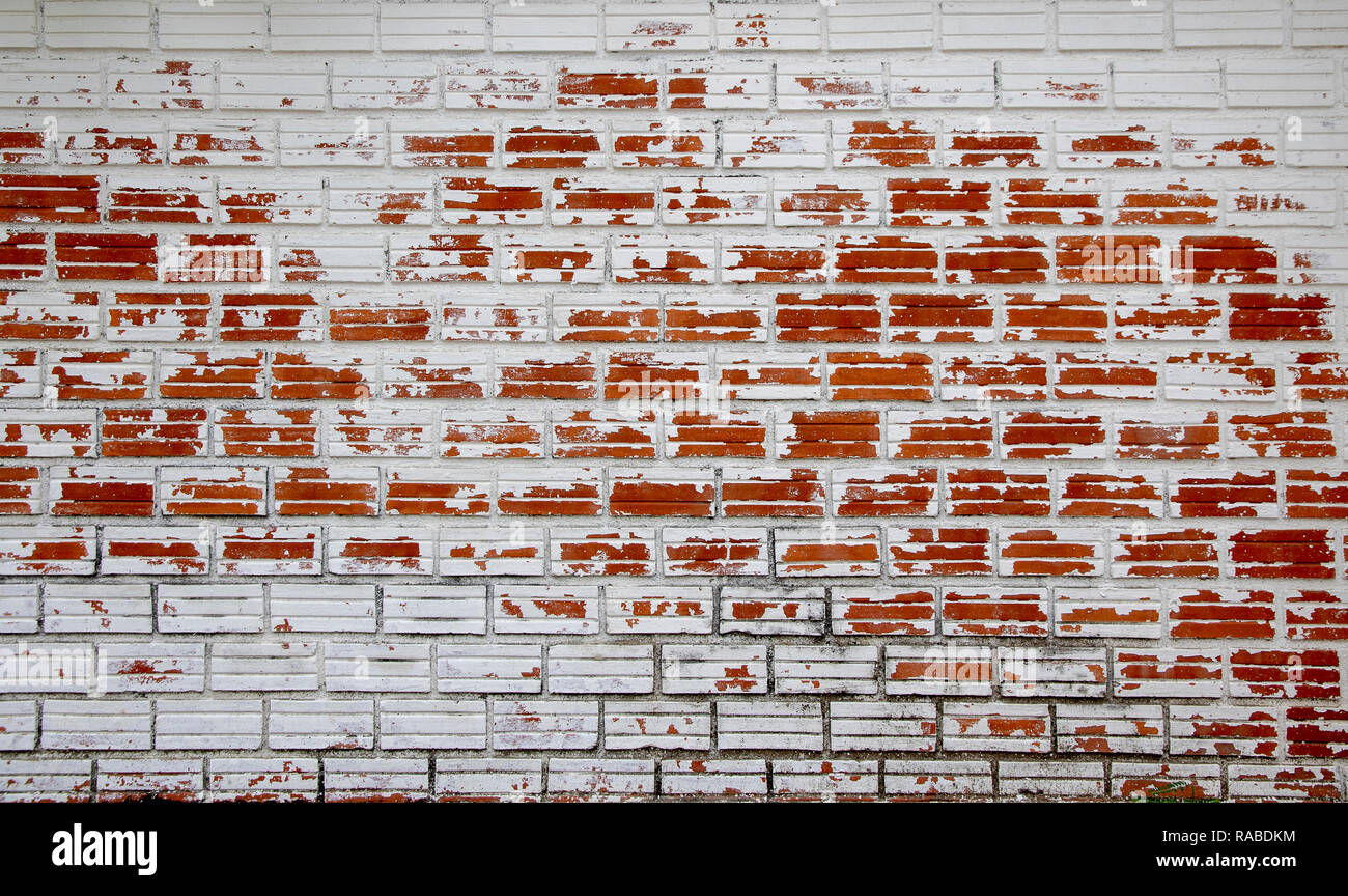 White peeling painted as old red brick wall. Stock Photo