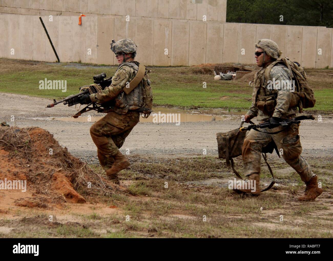 Infantry soldiers conducting live-fire training during realistic pre-deployment scenarios at Fort Polk