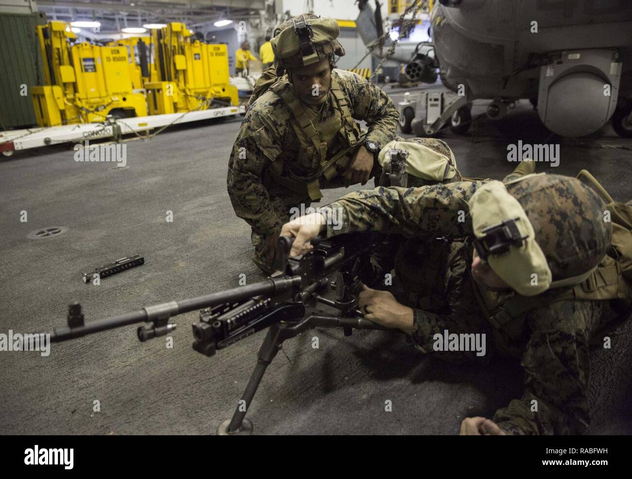 Lance Cpl. Barnabas Madison, a squad leader with 81st Platoon, Weapons Company, 3rd Battalion 6th Marine Regiment leads his Marines in immediate action drills in the well deck of USS Bataan (LHD 5) Jan. 22, 2017. Madison was recently awarded Marine of the Quarter for performing above and beyond his peers. Originally from Lake City, Florida, Madison has been in the Marine Corps for nearly two years and is currently attached to the 24th Marine Expeditionary Unit for his first deployment. Madison is planning to reenlist and make a career out of the Marine Corps. Stock Photo