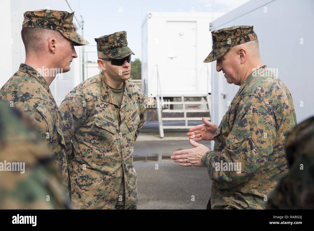 U.S. Marine Corps Gen. Glenn Walters, Assistant Commandant of the Marine Corps, right, speaks with Gunnery Sgt. Joseph Lowery, master gunner, 2nd Tank Battalion, 2nd Marine Division, in regards to the Advanced Gunnery Training System during a visit to Camp Lejeune, N.C., Jan. 26, 2017. The purpose of the visit was to increase awareness and capabilities of ground simulation and simulator training systems in support of operational forces combat readiness. Stock Photo