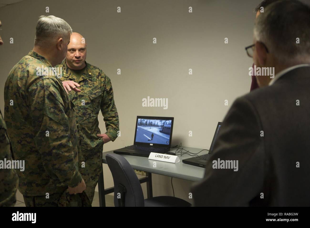 U.S. Marine Corps Maj. Craig L. Smith, right, modeling and simulation officer, II Marine Expeditionary Force (II MEF), briefs Gen. Glenn Walters the Assistant Commandant of the Marine Corps, on the usage of the II MEF Simulation Center during a visit to Camp Lejeune, N.C., Jan. 26, 2017. The purpose of the visit was to increase awareness and capabilities of ground simulation and simulator training systems in support of operational forces combat readiness. Stock Photo