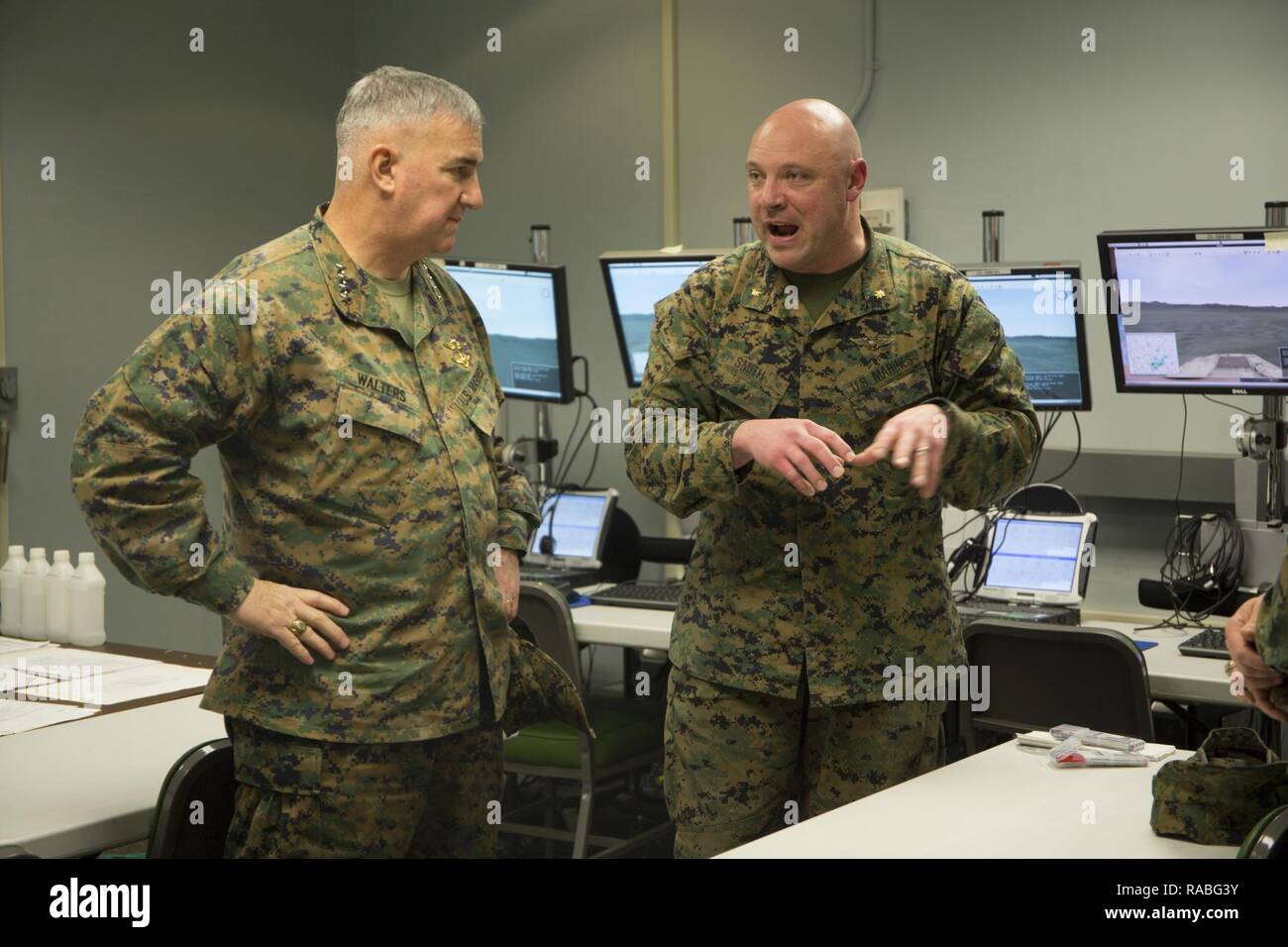 U.S. Marine Corps Maj. Craig L. Smith, right, modeling and simulation officer, II Marine Expeditionary Force (II MEF), briefs Gen. Glenn Walters, Assistant Commandant of the Marine Corps, on the usage of the II MEF Simulation Center during a visit to Camp Lejeune, N.C., Jan. 26, 2017. The purpose of the visit was to increase awareness and capabilities of ground simulation and simulator training systems in support of operational forces combat readiness. Stock Photo