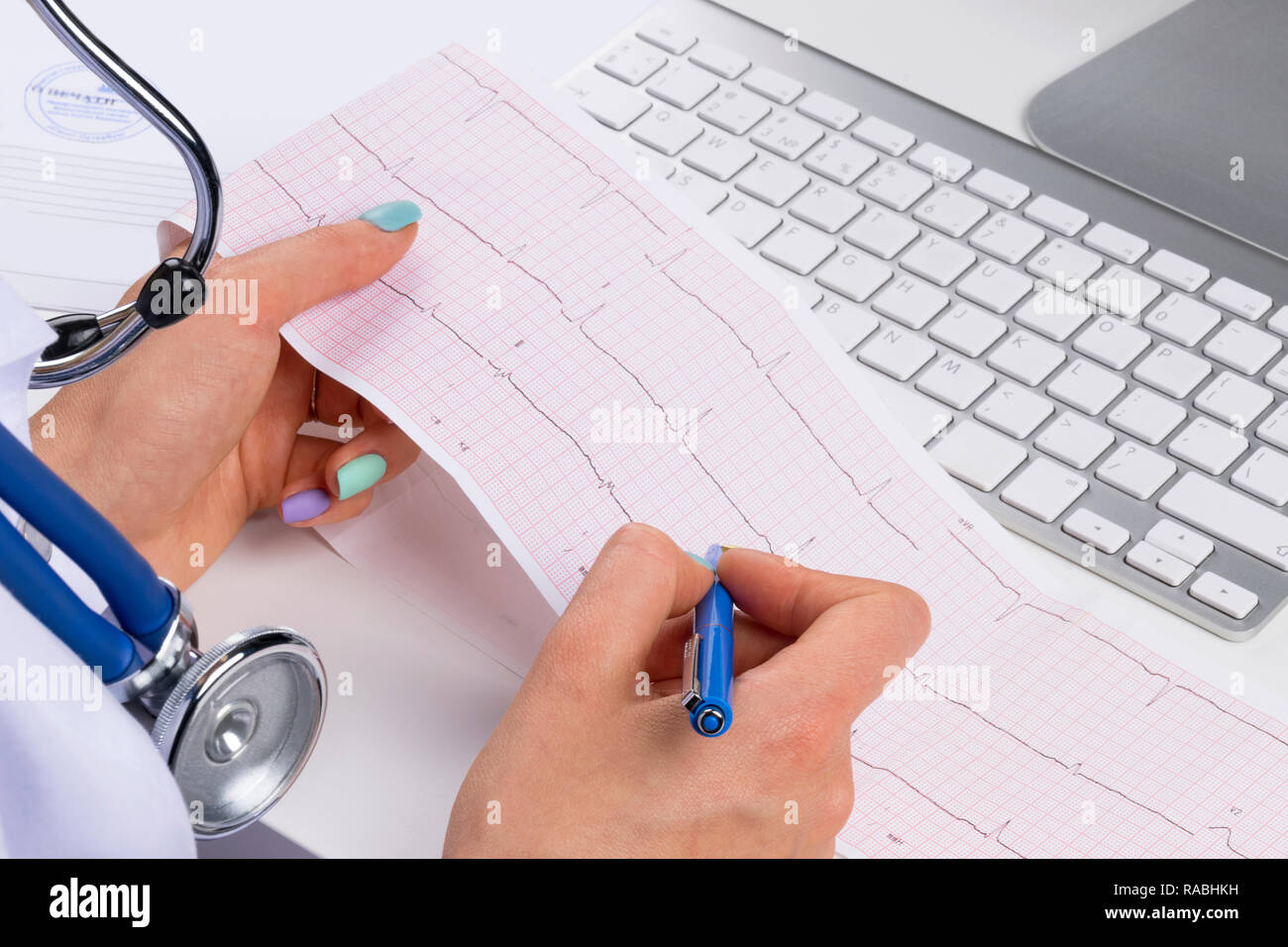 Doctor workplace. Electrocardiogram, ecg in hand of a female doctor