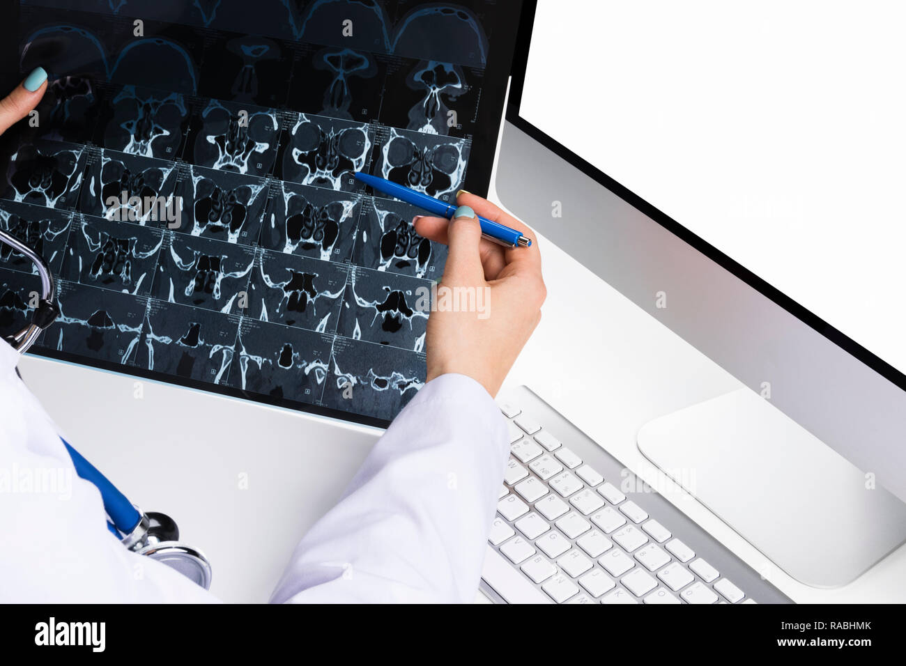 Doctor looking at computer tomography x-ray image, medicine doctor's working table with computer. Healthcare concept Stock Photo