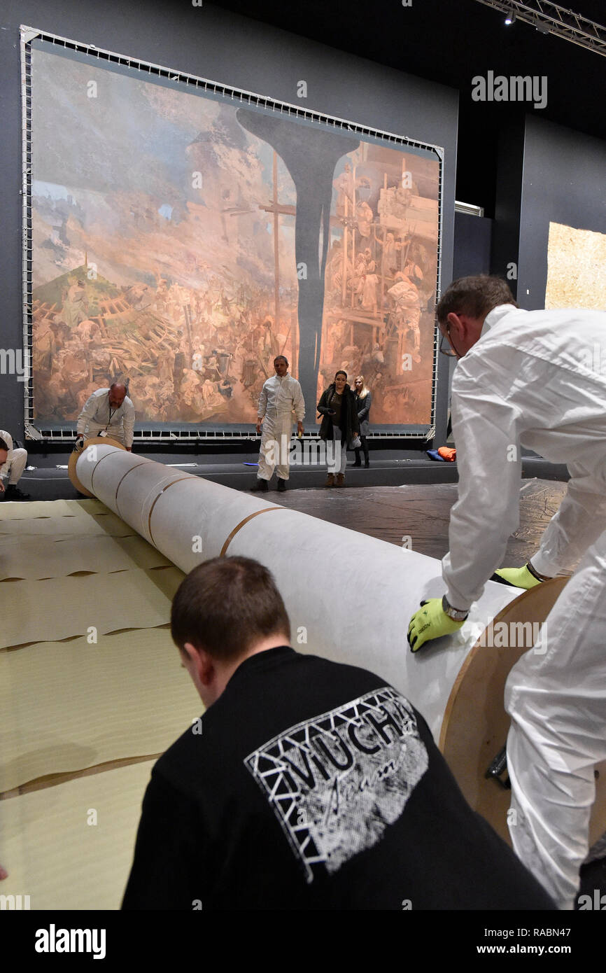 Brno, Czech Republic. 03rd Jan, 2019. Workers of the Prague City Gallery pack a part of The Slav Epic cycle of paintings by Czech Art Nouveau artist Alfons (Alphonse) Mucha (1860-1939), after the end of the 'Alfons Mucha - Two worlds' exhibition within the 'Re:publika' festival marking the 100th anniversary of the founding of Czechoslovakia, on January 3, 2019, in Brno, Czech Republic. On the background is seen painting named Defense of Sziget against the Turks by Nicholas Zrinsky. Credit: Vaclav Salek/CTK Photo/Alamy Live News Stock Photo