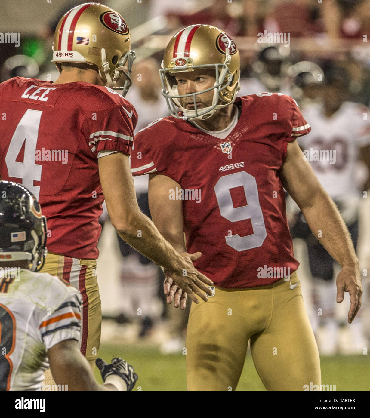 Santa Clara, California, USA. 14th Sep, 2014. San Francisco 49ers punter Andy Lee (4) shakes hands with kicker Phil Dawson (9) after his field goal on Sunday, September 14, 2014 in Santa Clara, California. The Bears defeated the 49ers 27-20. Credit: Al Golub/ZUMA Wire/Alamy Live News Stock Photo