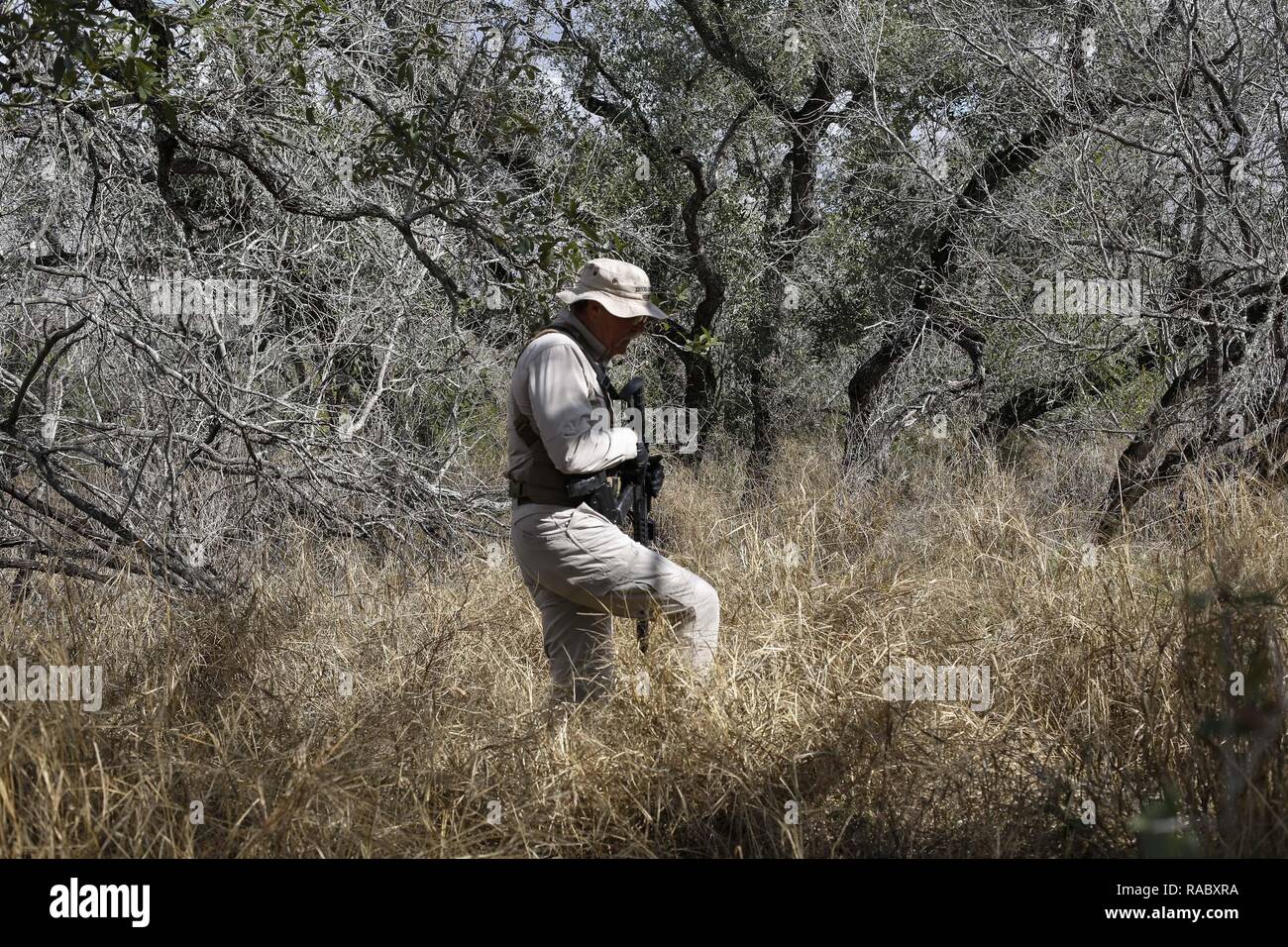 Volunteer Brooks County Sheriff deputy Don White walks on a ranch