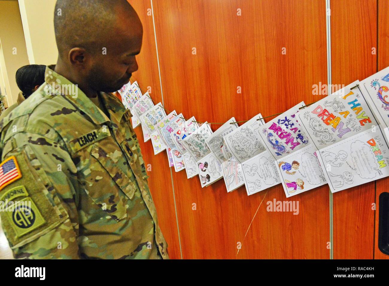 A Soldier from U.S. Army Africa observes children's drawings provided by the Vicenza Elementary School for Martin Luther King, Jr. Day during Vicenza Military Community’s 2017 Observance Ceremony at Caserma Ederle, Vicenza, Italy, Jan. 10, 2017. Stock Photo