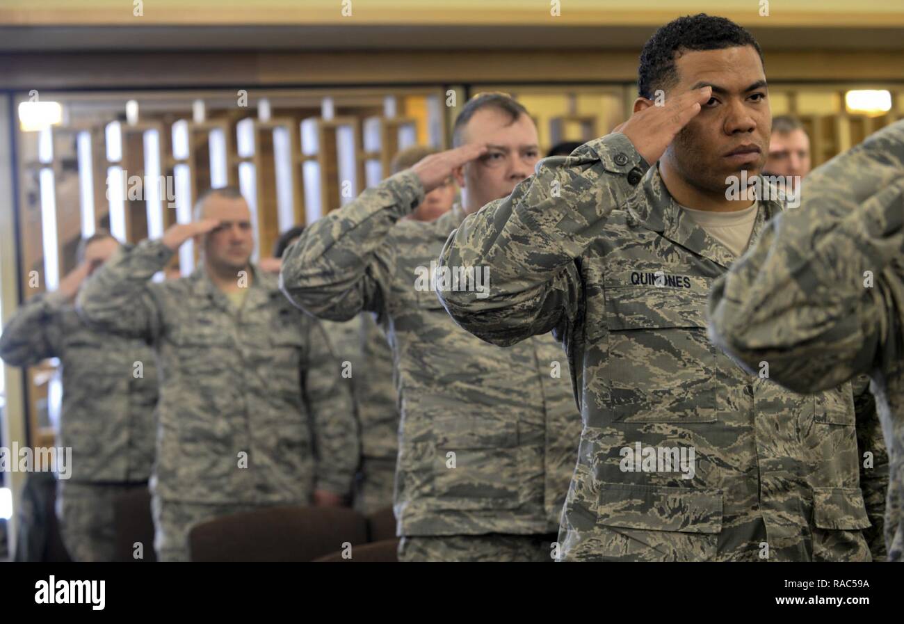 Airmen salute as Taps plays during Master Sgt. Scott W. Scovell’s