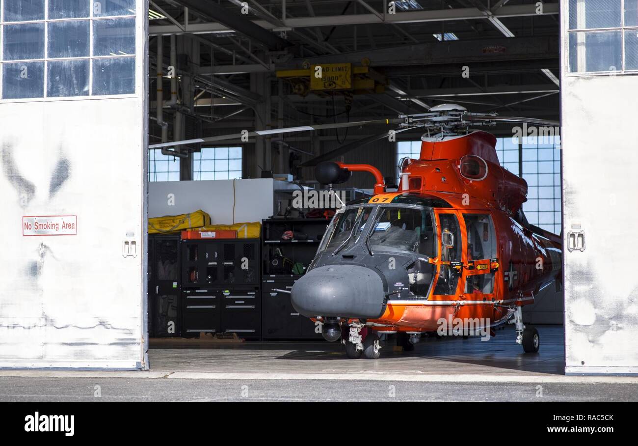 A Coast Guard Air Station San Fransisco MH-65 Dolphin helicopter stands ready inside the hanger at Forward Operating Base Point Mugu on January 11, 2017. The MH-65 Dolphin helicopter is used for search and rescue, law enforcement, and security missions. Stock Photo