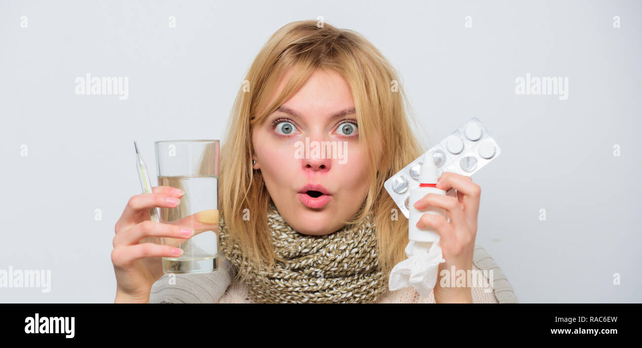 Drink plenty of fluids. Girl take medicine to break fever. Breaking