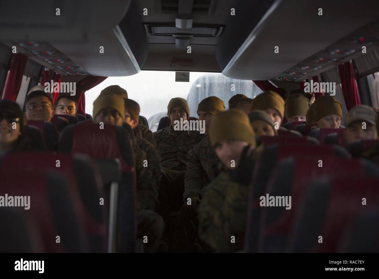 U.S. Marines board a bus on the tarmac headed to garrison at Vaernes Garnison, Norway, Jan. 16, 2017. The Marines with Black Sea Rotational Force 17.1 arrived at Vaernes Garnison early in the morning as part of Marine Rotational Force Europe 17.1. Stock Photo